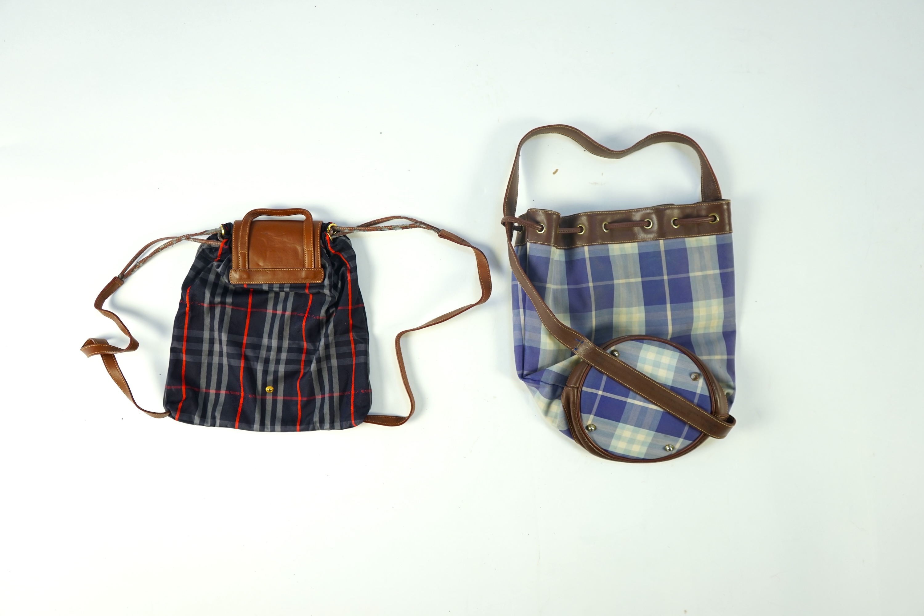 Two tartan canvas with leather trim Burberry bags, one backpack and one bucket bag